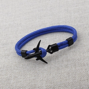 Minimalist blue paracord bracelet featuring a sleek black metal airplane charm