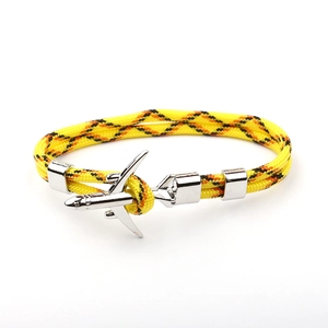 Close-up of woven polyester rope bracelet featuring a silver metal airplane charm
