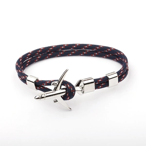 Detail of blue braided polyester rope bracelet with silver airplane charm clasp