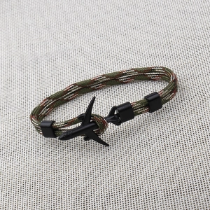 Close-up of camouflage 550 paracord bracelet with a black airplane metal buckle