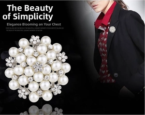Detail showing elegant pearl and rhinestone flower brooch with model wearing effect