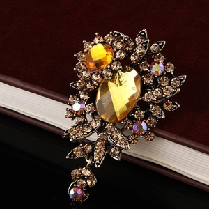Detailed macro of vintage flower brooch with yellow gemstones and champagne rhinestones