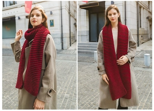 Close-up of thick wine red knit scarf showing premium handmade texture and warm fabric