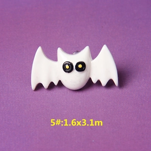 Macro shot of a white resin bat charm for DIY crafts with size specs 1.6x3.1cm