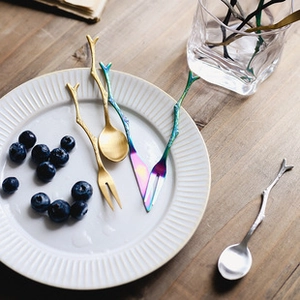 Artistic branch-shaped stainless steel spoons and forks in gold, silver, and rainbow colors