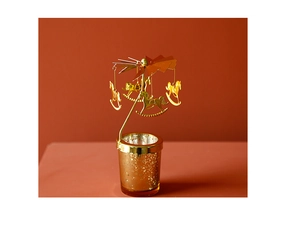 Detail of a rotating golden carousel candle holder with intricate horse pendants