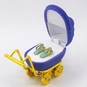 Blue velvet baby stroller jewelry box with golden frame and flip-flop earrings inside