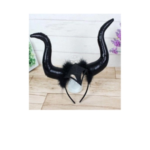 Macro detail of black glittery devil horns headband with soft feather accents