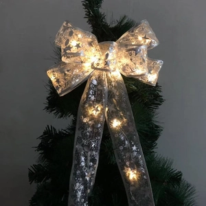 Silver LED Christmas tree topper bow with warm glowing lights and sequin details