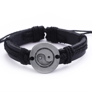 Retro black braided leather bracelet featuring a vintage silver Yin Yang metal charm