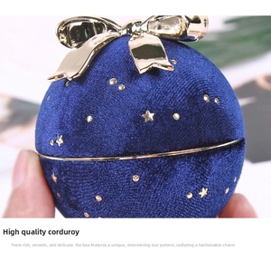 Macro view of blue velvet jewelry box with golden bow and star patterns