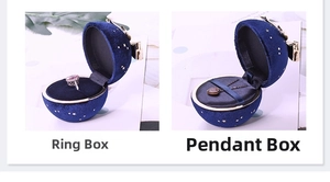 Detail of blue velvet jewelry boxes with star patterns and gold bow clasps for rings
