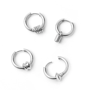 Detail of four silver stainless steel hoop earrings in punk and hip-hop styles