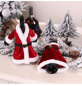 Detailed view of velvet Santa suit wine bottle covers with white faux fur trim and gold buckle