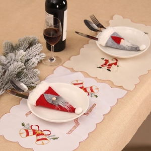 Christmas table decoration set with red and grey Santa hat cutlery holders and embroidered placemats