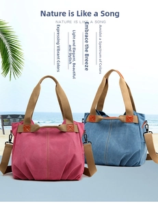 Detailed view of canvas tote bags with leather accents and woven handles in beach setting