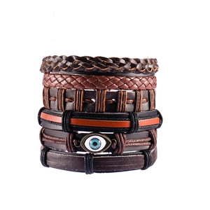Detail of multi-layer leather bracelets featuring the Evil Eye charm and woven texture