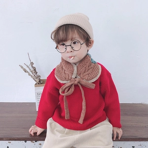 Detail of cable knit pattern and beige faux shearling lining on kids scarf