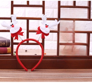 Close-up of plush reindeer headbands with red bows on dynamic metal springs