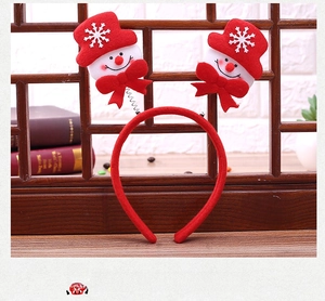Detail of Christmas headband featuring snowman figures with springs and red velvet wrap