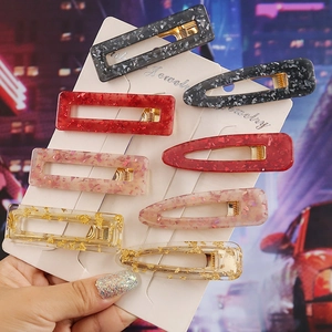 Detailed set of eight leopard marble resin hair clips with glitter foil in hand