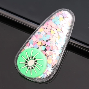 Close-up of kiwi fruit hair clip with colorful heart-shaped glitters inside the base