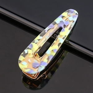 Detail of hollow acetate hair clip with lavender and sky blue celestial patterns