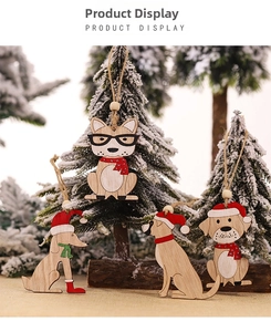 Close-up of rustic wooden dog ornaments with Christmas hats and scarves on pine branches