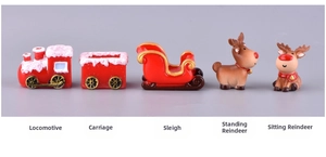 Detail of Christmas resin figurines including a locomotive, sleigh, and reindeer models