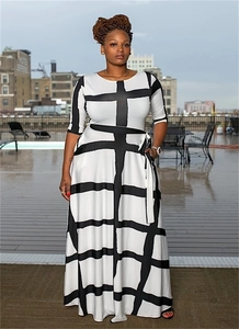 Detail of plus size striped dress featuring black and white patterns with a waist tie
