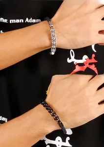 Close-up of men's braided leather bracelets with steel beads and punk style details