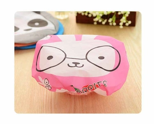 Close-up of pink cartoon shower cap with waterproof PE material and elastic band detail