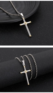 Detailed view of silver and gold stainless steel cross pendant with a sturdy box chain