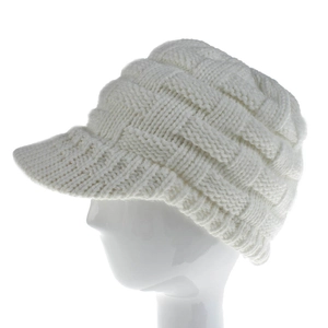 Detail view of the cable knit pattern and brim on this beige winter ponytail baseball cap