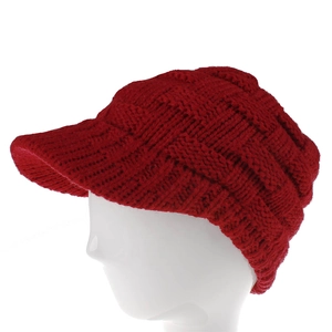 Close-up of red knit visor beanie featuring thick textured cable knit and curved brim