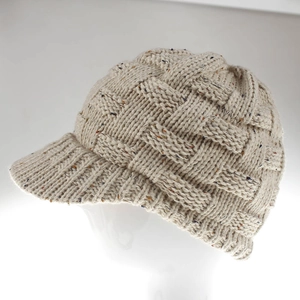 Detail view of cream knit beanie with colorful flecks and basket weave texture