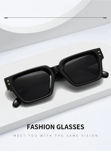 Detailed close-up of fashion square sunglasses with gold rivets on elegant display stand