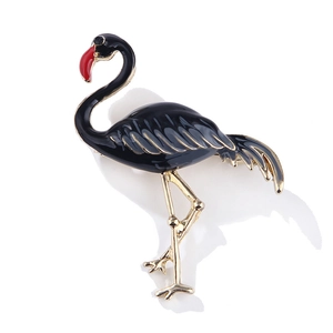 Macro detail of elegant black enamel and gold plated flamingo brooch with realistic texture