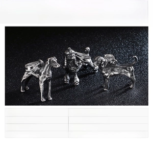 Detailed close-up of stainless steel poodle pendants with textured metal finishes