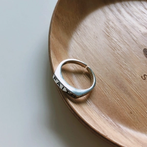 Macro shot of 925 sterling silver ring showing the FAITH engraving and S925 stamp