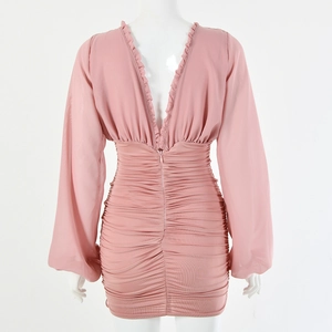Detailed back view of pink long sleeve ruched dress with deep V-neck and ruffle trim