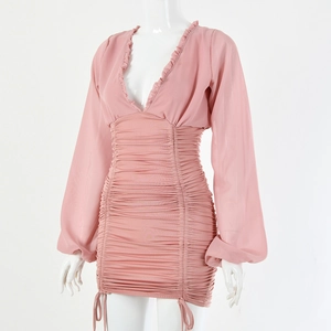 Close-up of pink mini dress with deep V-neck and delicate ruffled details on mannequin