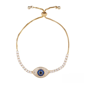 Detailed view of golden evil eye bracelet with white zircon inlay and box chain