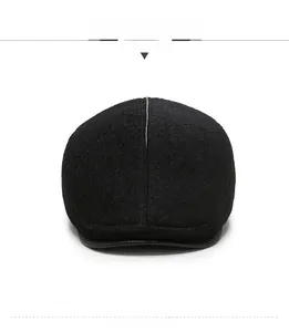 Front view detail of wool blend newsboy cap for men featuring a leather brim finish