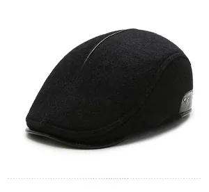 Detailed close-up of a black wool flat cap with leather brim and silver metal rivets