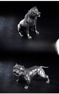 Detail of stainless steel dog figurines showing realistic muscle lines and metallic texture