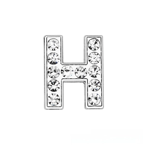 Macro detail of silver chrome H letter charm with 12 sparkling inlaid crystals