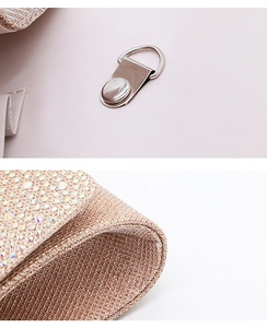 Detailed close-up of gold metal hardware and sparkling rhinestone fabric on the evening bag
