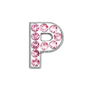 Macro detail of silver letter P charm with pave-set pink rhinestones on white base