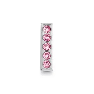Detail showing chrome-finished rectangle charm with five inlaid pink sparkling crystals